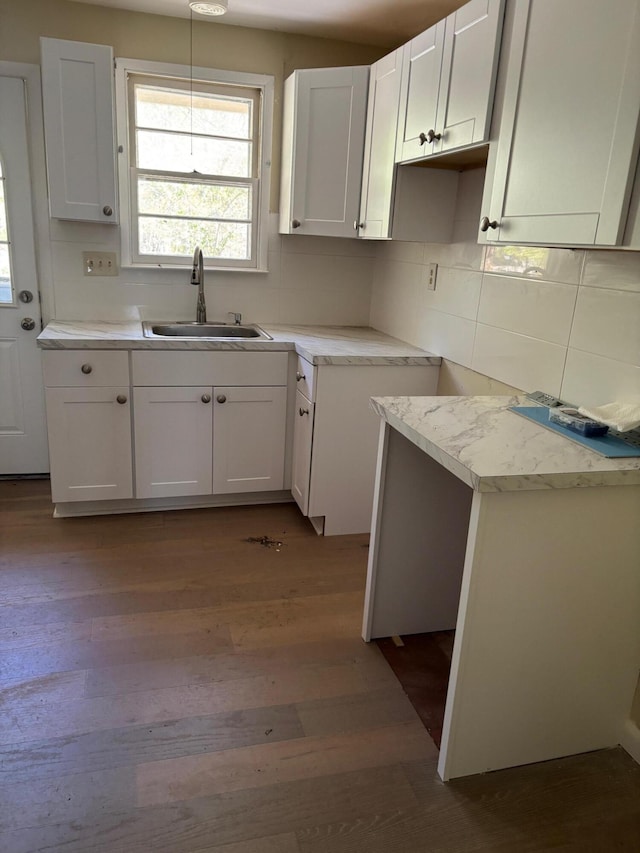83 Partridge Valley Rd, West Yarmouth, MA 02673 - kitchen with a sink, wood finished floors, tasteful backsplash, and white cabinetry