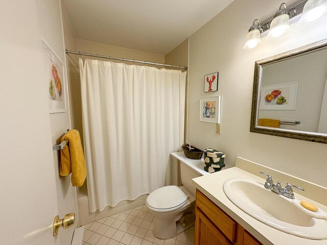 full bathroom featuring tile patterned floors, toilet, vanity, and shower / tub combo with curtain