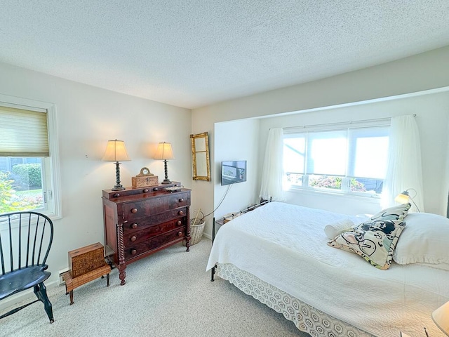 carpeted bedroom featuring a textured ceiling