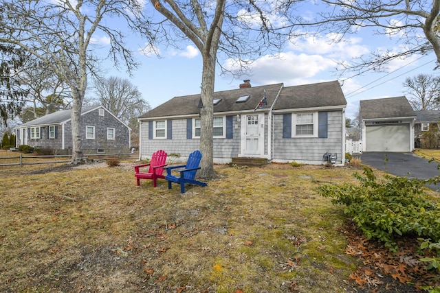 16 Indian Pond Rd, West Dennis, MA 02670 - view of front of house with fence, a chimney, entry steps, an outdoor structure, and a garage