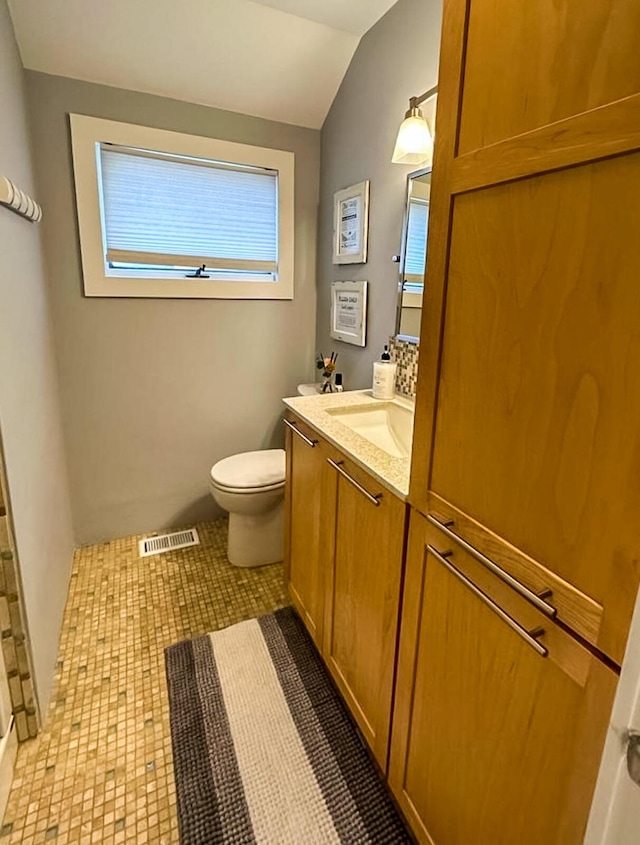 31 Northern Ave, Dennis Port, MA 02639 - bathroom featuring toilet, vanity, and vaulted ceiling
