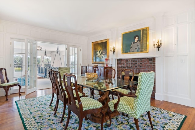 dining room with wood-type flooring, crown molding, and french doors