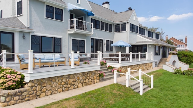 back of house with a lawn and an outdoor hangout area