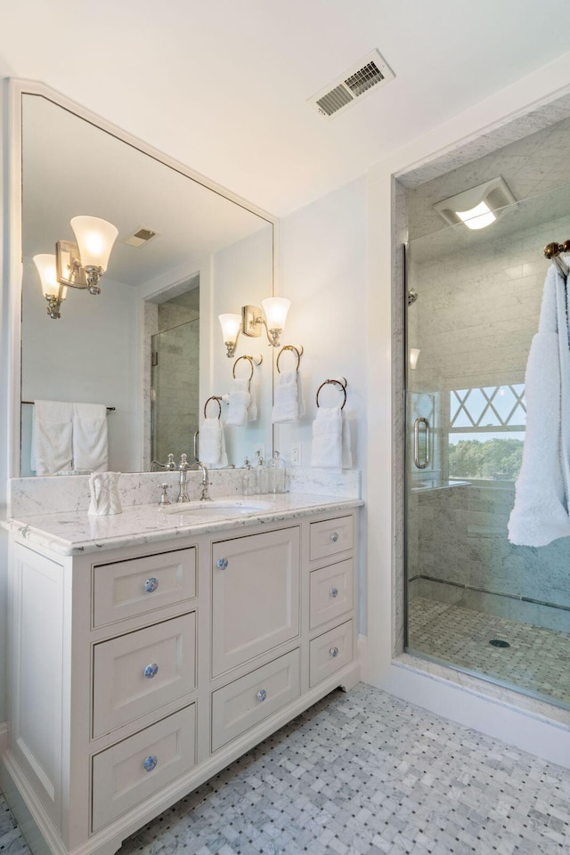 bathroom with an enclosed shower, a notable chandelier, and vanity