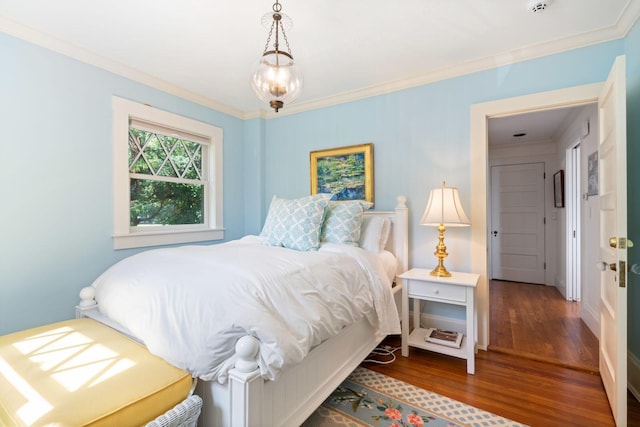 bedroom featuring wood-type flooring and ornamental molding