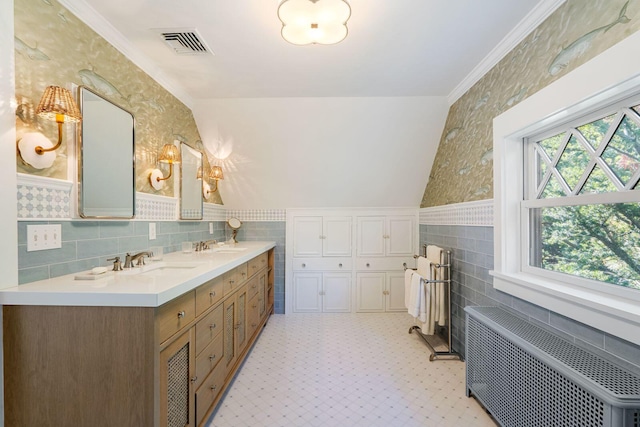 bathroom featuring vanity, radiator, tile walls, and lofted ceiling