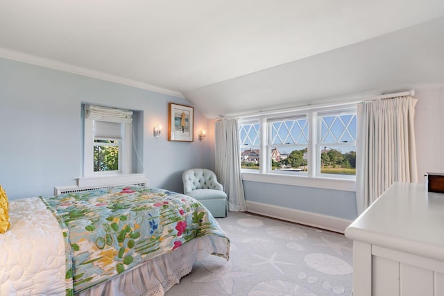 bedroom with vaulted ceiling, radiator, light carpet, and multiple windows