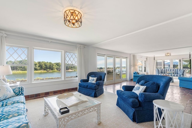 living room with a water view and french doors