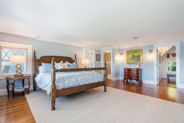 bedroom with hardwood / wood-style flooring and ornamental molding