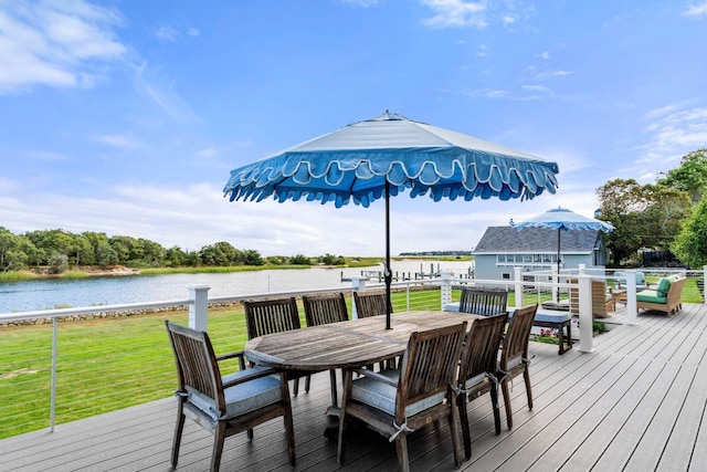 deck with a water view and a yard