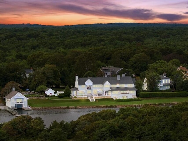 aerial view at dusk with a water view