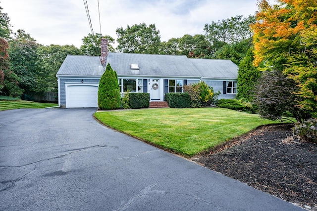 view of front facade with a garage and a front lawn