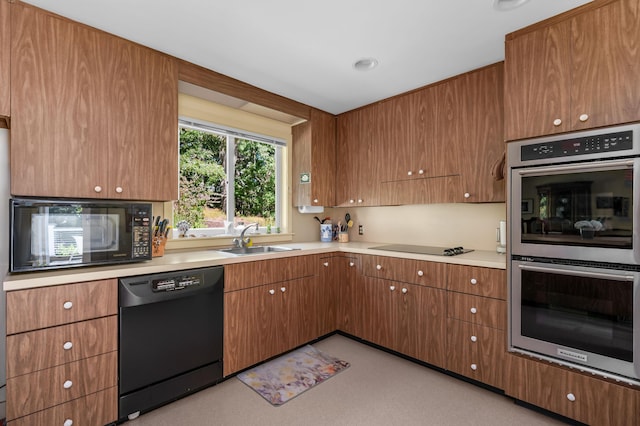 139 Prince Ave, Marstons Mills, MA 02648 - kitchen with black appliances, light countertops, and brown cabinetry
