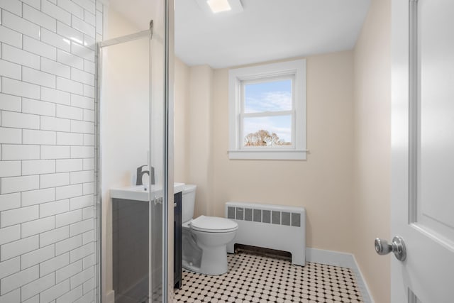 bathroom with toilet, radiator, and an enclosed shower