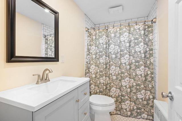 bathroom with toilet, vanity, radiator, and a shower with curtain