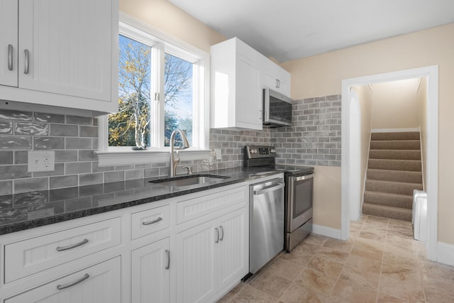 kitchen with sink, white cabinets, and stainless steel appliances