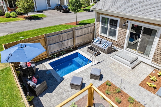 view of pool with an outdoor living space and a patio