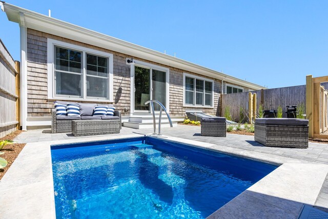 back of house featuring a fenced in pool, a patio, and outdoor lounge area