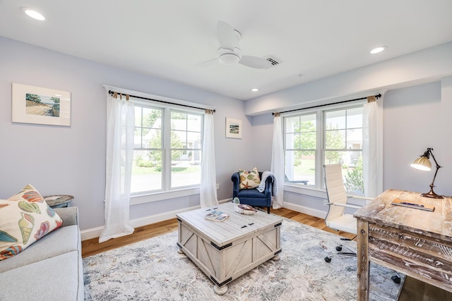 office space featuring light wood-type flooring and ceiling fan