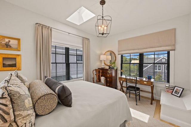 350 Bradford St Unit U7, Provincetown, MA 02657 - bedroom with a skylight, baseboards, and a chandelier