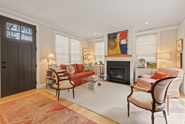 350 Bradford St Unit U7, Provincetown, MA 02657 - living room with crown molding, wood finished floors, a fireplace with flush hearth, baseboards, and recessed lighting
