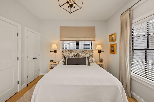 350 Bradford St Unit U7, Provincetown, MA 02657 - bedroom featuring light wood finished floors, a chandelier, and baseboards
