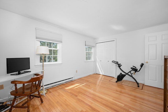office space featuring light wood-style floors and baseboard heating