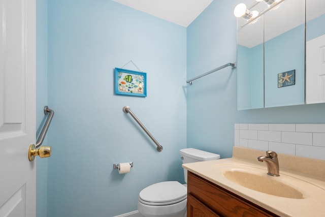 half bath featuring toilet, vanity, and tasteful backsplash