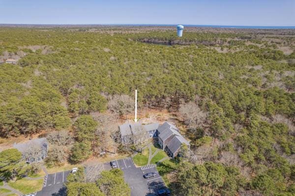 birds eye view of property featuring a wooded view