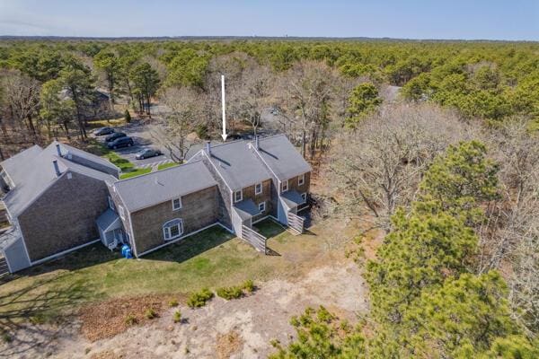 birds eye view of property with a forest view