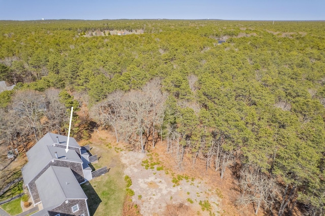 drone / aerial view featuring a wooded view