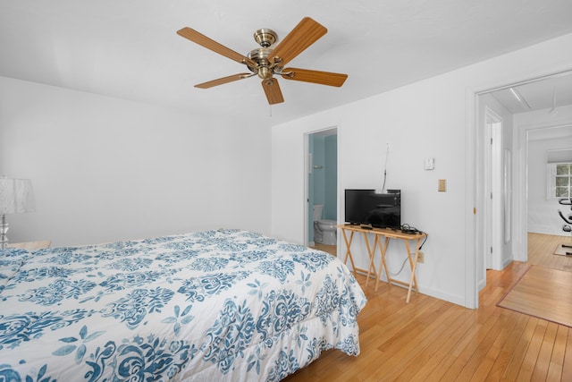 bedroom featuring baseboards, light wood-type flooring, attic access, and ceiling fan