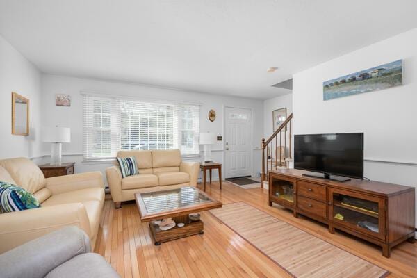 living room with stairway and light wood finished floors