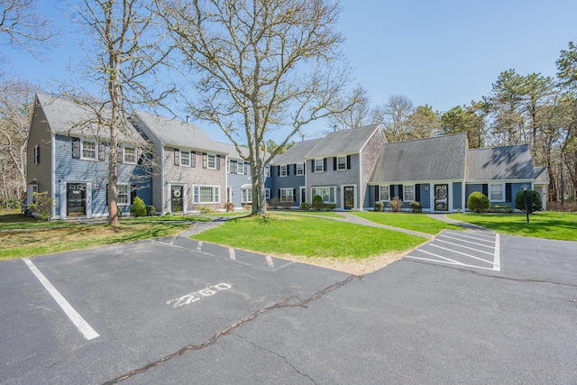 view of building exterior with a residential view and uncovered parking