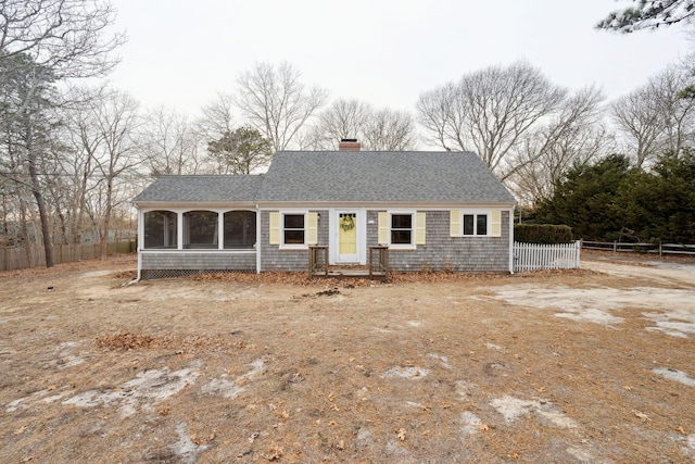 single story home featuring a shingled roof, fence, and a chimney