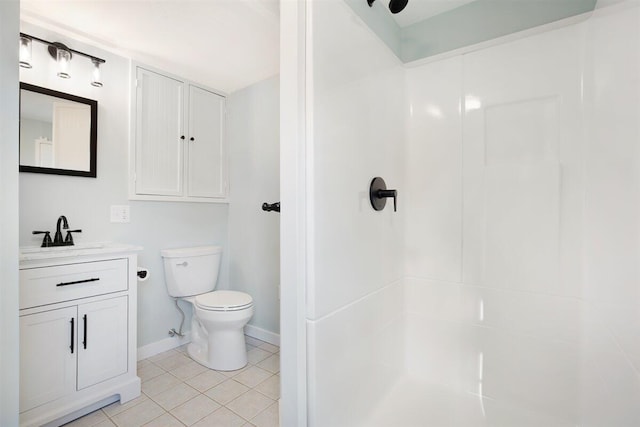 bathroom with toilet, vanity, walk in shower, and tile patterned flooring