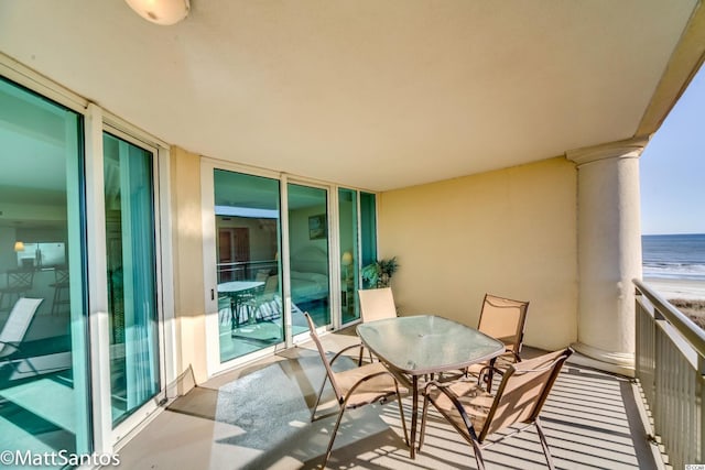 balcony with a view of the beach and a water view