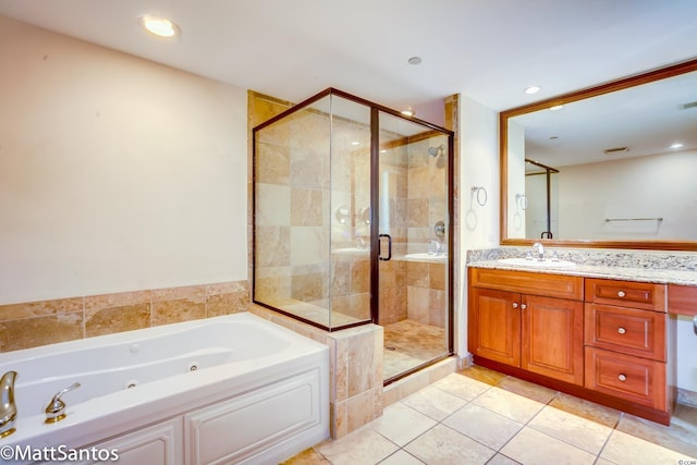 bathroom with vanity, plus walk in shower, and tile patterned flooring