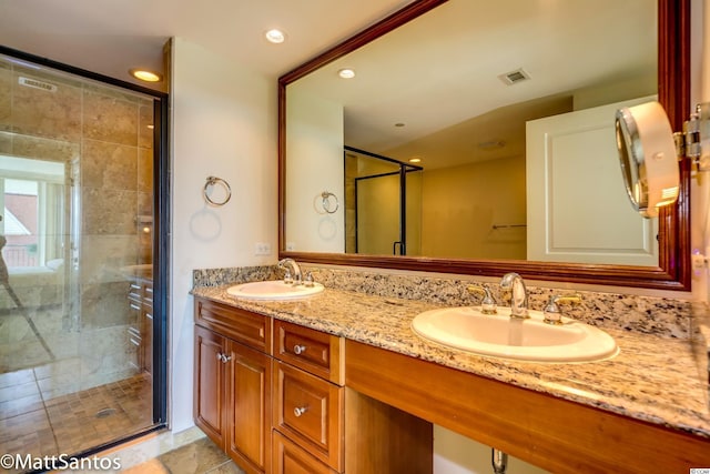 bathroom featuring walk in shower, tile patterned flooring, and vanity