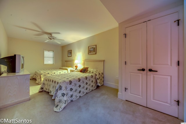 carpeted bedroom with a closet and ceiling fan