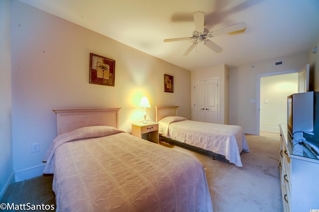 bedroom with a closet, light carpet, and ceiling fan