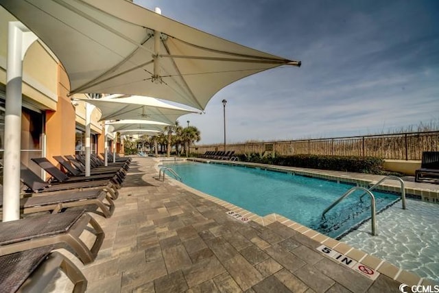 view of swimming pool with a patio