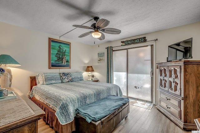 bedroom with a textured ceiling, access to exterior, ceiling fan, and light wood-type flooring