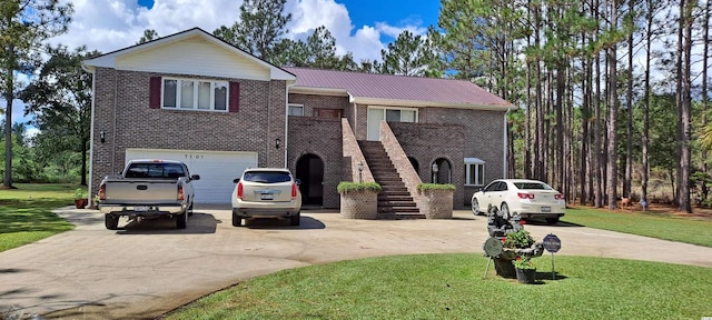 view of front of home with a garage and a front lawn