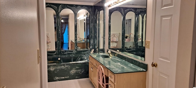 bathroom with a textured ceiling, vanity, and a tub to relax in