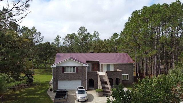 view of front of home with a garage and a front lawn