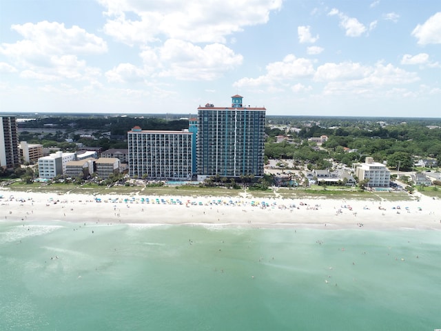 drone / aerial view featuring a beach view and a water view