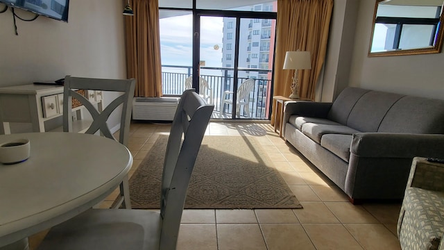 interior space featuring light tile flooring and a wall of windows