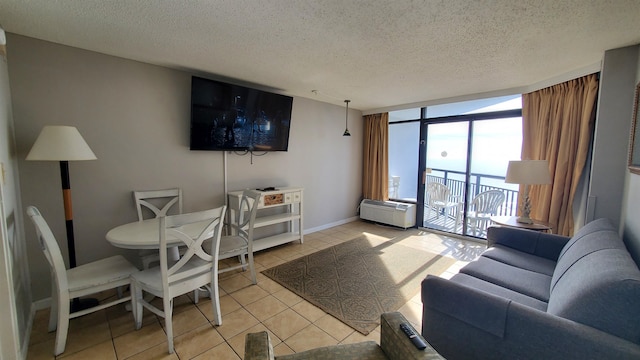 living room with floor to ceiling windows, a textured ceiling, and light tile floors