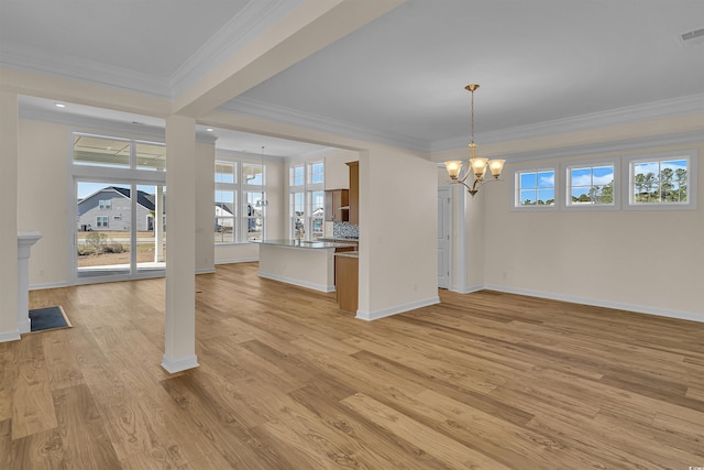 1228 Colusa Ct, Little River, SC 29566 - unfurnished dining area featuring a chandelier, ornamental molding, light wood-style flooring, and healthy amount of natural light